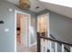 Hallway on the second level, with a doorway to the left and a doorway to a bathroom on the right at 4520 Dallas St, Acworth, GA 30101