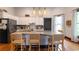Bright kitchen features white cabinets, a center island with bar stools, and modern appliances at 4520 Dallas St, Acworth, GA 30101