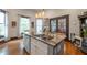 Bright kitchen with stone countertops, an island with seating, and wood floors at 4520 Dallas St, Acworth, GA 30101