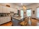 Bright kitchen features white cabinets, a center island with bar stools, and modern appliances at 4520 Dallas St, Acworth, GA 30101