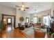 Open-concept living room features hardwood floors, ceiling fans, and comfortable leather seating at 4520 Dallas St, Acworth, GA 30101