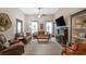 Spacious living room boasts hardwood floors, a ceiling fan, and cozy fireplace at 4520 Dallas St, Acworth, GA 30101