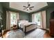 Spacious main bedroom with hardwood floors, two windows, and a ceiling fan at 4520 Dallas St, Acworth, GA 30101