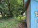 View of an unkempt yard with greenery and trees surrounding the building at 562 English Nw Ave, Atlanta, GA 30318