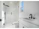 Modern bathroom with a sleek glass-enclosed shower, contemporary fixtures, and bright natural light at 0 Thompson Mill Rd, Buford, GA 30519