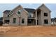 Two story home with brick exterior, black trim, and an unfinished front yard at 0 Thompson Mill Rd, Buford, GA 30519