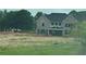 Elegant two-story home with a well-manicured front lawn and attractive curb appeal at 0 Thompson Mill Rd, Buford, GA 30519