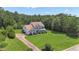 Expansive property featuring a two-story home, lush lawn and mature trees at 102 Plantation Dr, Lagrange, GA 30277