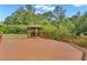 Relax on this large wooden back deck featuring a gazebo surrounded by a lush wooded area at 102 Plantation Dr, Lagrange, GA 30277