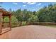 Enjoy outdoor living on this expansive deck complete with a charming gazebo and wooded views at 102 Plantation Dr, Lagrange, GA 30277