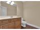 Powder room with a wood vanity and a toilet at 102 Plantation Dr, Lagrange, GA 30277