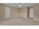 Large bedroom with carpet, ceiling fan, and two doors leading to other rooms offers lots of flexible space at 102 Plantation Dr, Lagrange, GA 30277