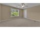 Spacious bedroom with carpet and a large window overlooking the neighborhood features neutral wall colors at 102 Plantation Dr, Lagrange, GA 30277