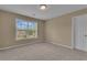 Bedroom with carpet and a view of the neighborhood through the large window offers a relaxing space at 102 Plantation Dr, Lagrange, GA 30277