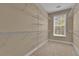 Walk-in closet with carpet and window features lots of built-in wire shelving for storage at 102 Plantation Dr, Lagrange, GA 30277