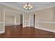 Formal dining room featuring hardwood floors, chair rail, and access to other living spaces at 102 Plantation Dr, Lagrange, GA 30277