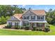 Charming two-story home with stone accents, manicured lawn, and covered front porch at 102 Plantation Dr, Lagrange, GA 30277