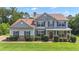 Charming two-story home with stone accents, manicured lawn, and covered front porch at 102 Plantation Dr, Lagrange, GA 30277
