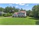 Charming two-story home with a large front yard and mature trees at 102 Plantation Dr, Lagrange, GA 30277