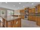 Well-equipped kitchen with an island, tile backsplash, and ample cabinet space at 102 Plantation Dr, Lagrange, GA 30277