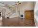 Spacious living room with a fireplace, hardwood floors, and a staircase leading to the second floor at 102 Plantation Dr, Lagrange, GA 30277