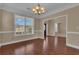 Bright living room with hardwood floors, chair rail, and front yard views at 102 Plantation Dr, Lagrange, GA 30277