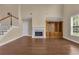 Cozy living room with fireplace, built-in shelving, and hardwood floors at 102 Plantation Dr, Lagrange, GA 30277