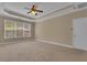 Main bedroom with tray ceiling and natural light from the window at 102 Plantation Dr, Lagrange, GA 30277