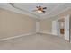 Spacious main bedroom with tray ceiling, carpet floors and ensuite access at 102 Plantation Dr, Lagrange, GA 30277