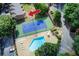 Aerial view of the pool, tennis court, landscaping, and surrounding neighborhood at 1301 Parkaire Xing, Marietta, GA 30068
