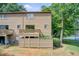 Back exterior elevation with a private fenced yard and wooden deck overlooking mature trees at 1301 Parkaire Xing, Marietta, GA 30068
