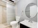 Bathroom features a shower, toilet, and vanity with a round mirror at 1301 Parkaire Xing, Marietta, GA 30068