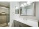 Modern bathroom with updated vanity, large mirror, and a tiled shower with glass door at 1301 Parkaire Xing, Marietta, GA 30068