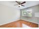 Bedroom with hardwood floors, neutral paint, ceiling fan, and window with natural light at 1301 Parkaire Xing, Marietta, GA 30068