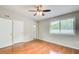 Spacious bedroom with hardwood floors, a ceiling fan, and large windows for natural light at 1301 Parkaire Xing, Marietta, GA 30068