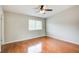 A bright bedroom with hardwood floors, neutral walls, and a ceiling fan at 1301 Parkaire Xing, Marietta, GA 30068