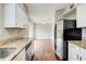 Bright kitchen with stainless steel appliances, granite counters, and hardwood floors at 1301 Parkaire Xing, Marietta, GA 30068