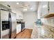 Well-lit kitchen featuring stainless steel appliances, granite countertops, and stylish cabinets at 1301 Parkaire Xing, Marietta, GA 30068