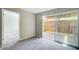 Carpeted living room with sliding glass doors to a fenced outdoor space at 1301 Parkaire Xing, Marietta, GA 30068