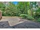 Backyard patio with stone pavers, surrounded by mature trees and greenery at 1618 Mason Mill Ne Rd, Atlanta, GA 30329