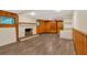 Basement featuring a brick fireplace, wood-paneled walls, and vinyl flooring at 1618 Mason Mill Ne Rd, Atlanta, GA 30329