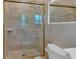 Tiled bathroom featuring a glass shower with gold trim and a toilet at 1618 Mason Mill Ne Rd, Atlanta, GA 30329