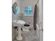 Traditional bathroom with pedestal sink, window, and tiled floors, combining classic style and functionality at 1618 Mason Mill Ne Rd, Atlanta, GA 30329
