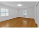 Bright bedroom featuring hardwood floors and white walls, enhanced by natural light at 1618 Mason Mill Ne Rd, Atlanta, GA 30329