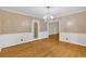 Classic dining room showcasing hardwood floors, white wainscoting, a chandelier, and an open doorway at 1618 Mason Mill Ne Rd, Atlanta, GA 30329