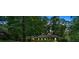 Traditional single-story brick home nestled among mature trees and greenery at twilight at 1618 Mason Mill Ne Rd, Atlanta, GA 30329
