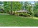 Traditional single-story brick home nestled among mature trees and greenery at 1618 Mason Mill Ne Rd, Atlanta, GA 30329