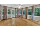 Bright sunroom with hardwood floors, multiple windows, and backyard access, providing a relaxing space at 1618 Mason Mill Ne Rd, Atlanta, GA 30329