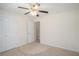 Bright bedroom with light carpet features a double door closet and a hallway view at 40 Browning Dr, Covington, GA 30016