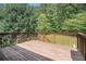Outdoor deck with wooden railings overlooks lush greenery, perfect for relaxation at 40 Browning Dr, Covington, GA 30016